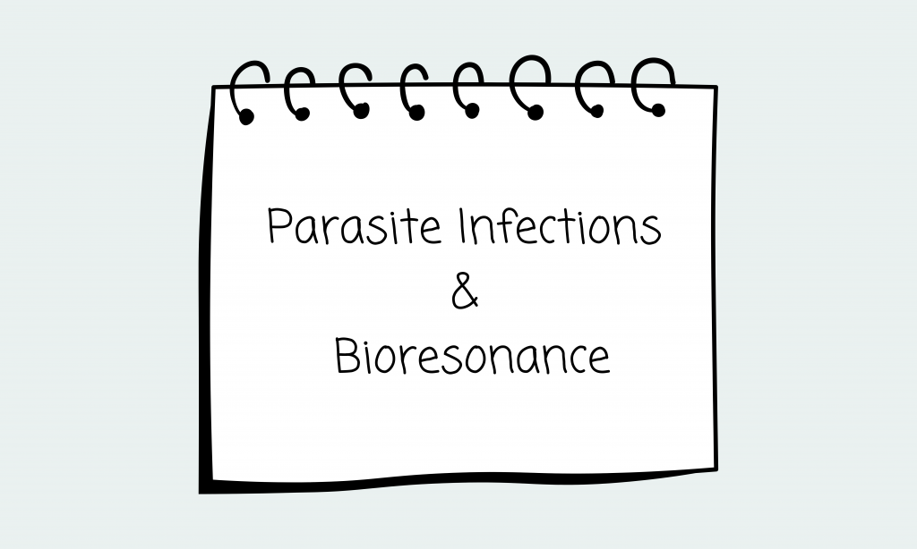 notepad with parasite and infections & bioresonance written on it