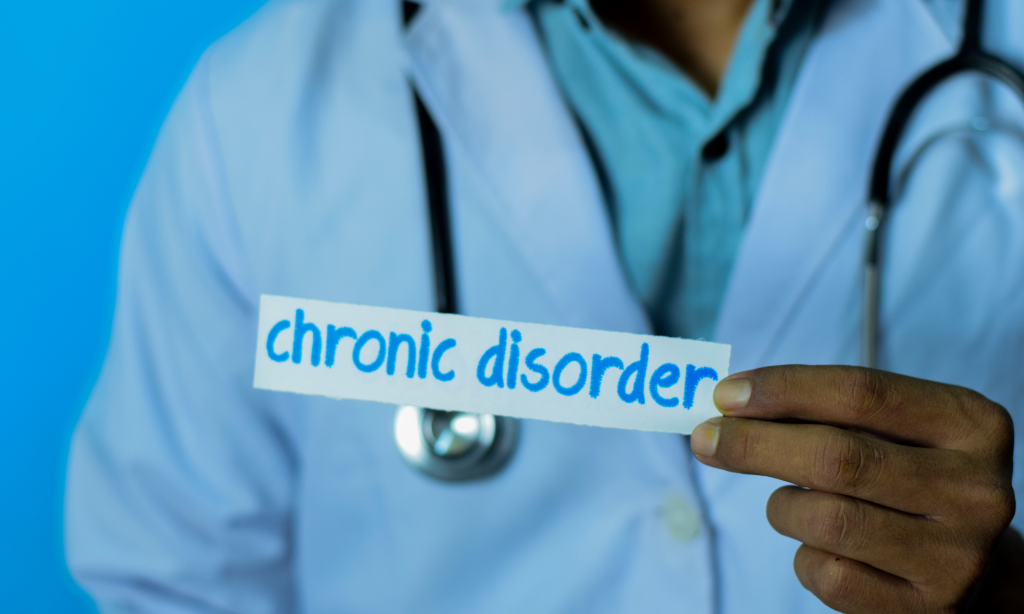 Doctor holding a card with text chronic disorder. Medical and healthcare concept