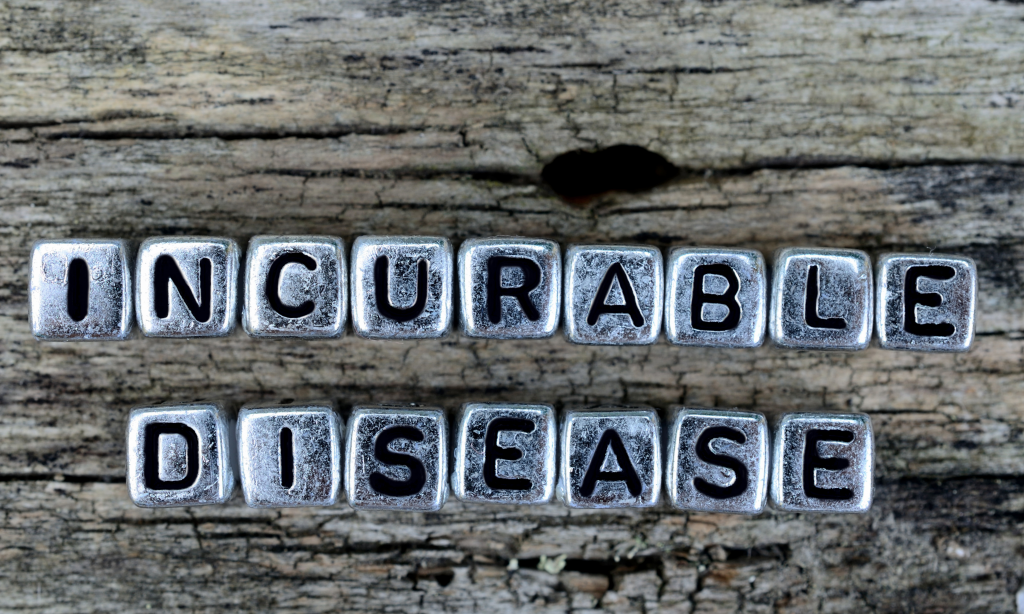 silver letter blocks spelling incurable disease on a wooden background