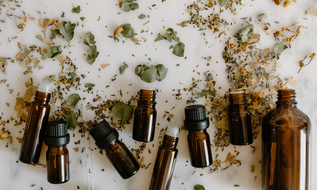 homeopathy bottles mixed with leaves and dried herbs