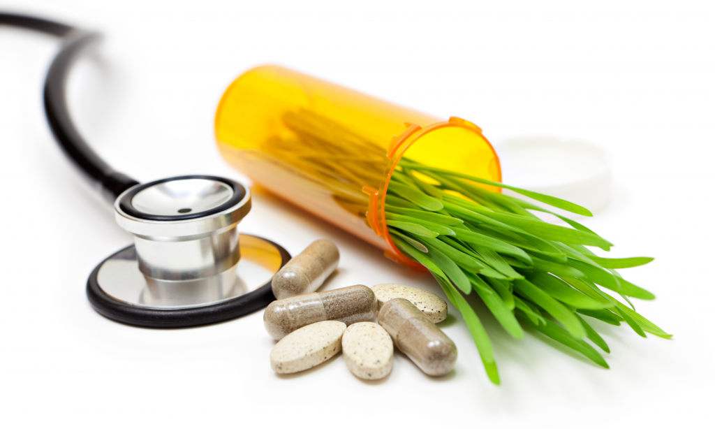 Holistic healthcare concept with stethoscope, natural ingredient supplements and pills
