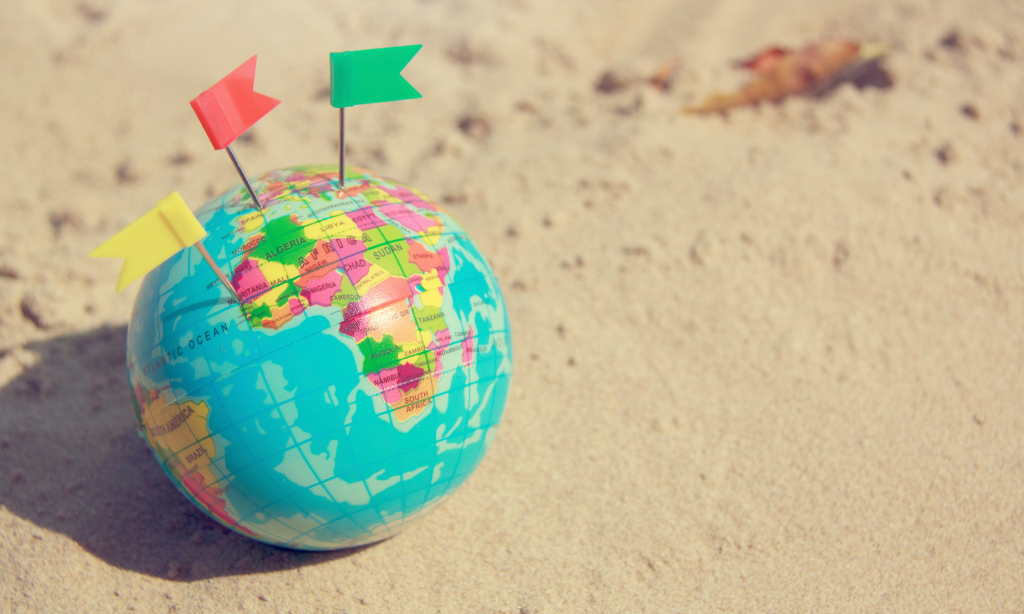 globe on the sand with peg flags in it