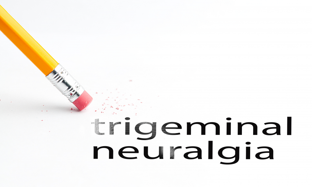 words trigeminal neuralgia in black font on a white background with pencil beginning to erase the word